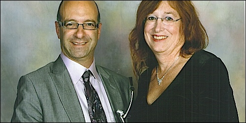 Adam Bernard, chair of GM PLUS, with Tina Seitz, GM PLUS board member, holding their Outie award for the 2009 Out & Equal…