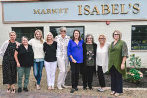 Isabel's Market & Eatery Co-Owner Garnet Lewis (center) stands in front of the shop with her business partners. Courtesy photo.