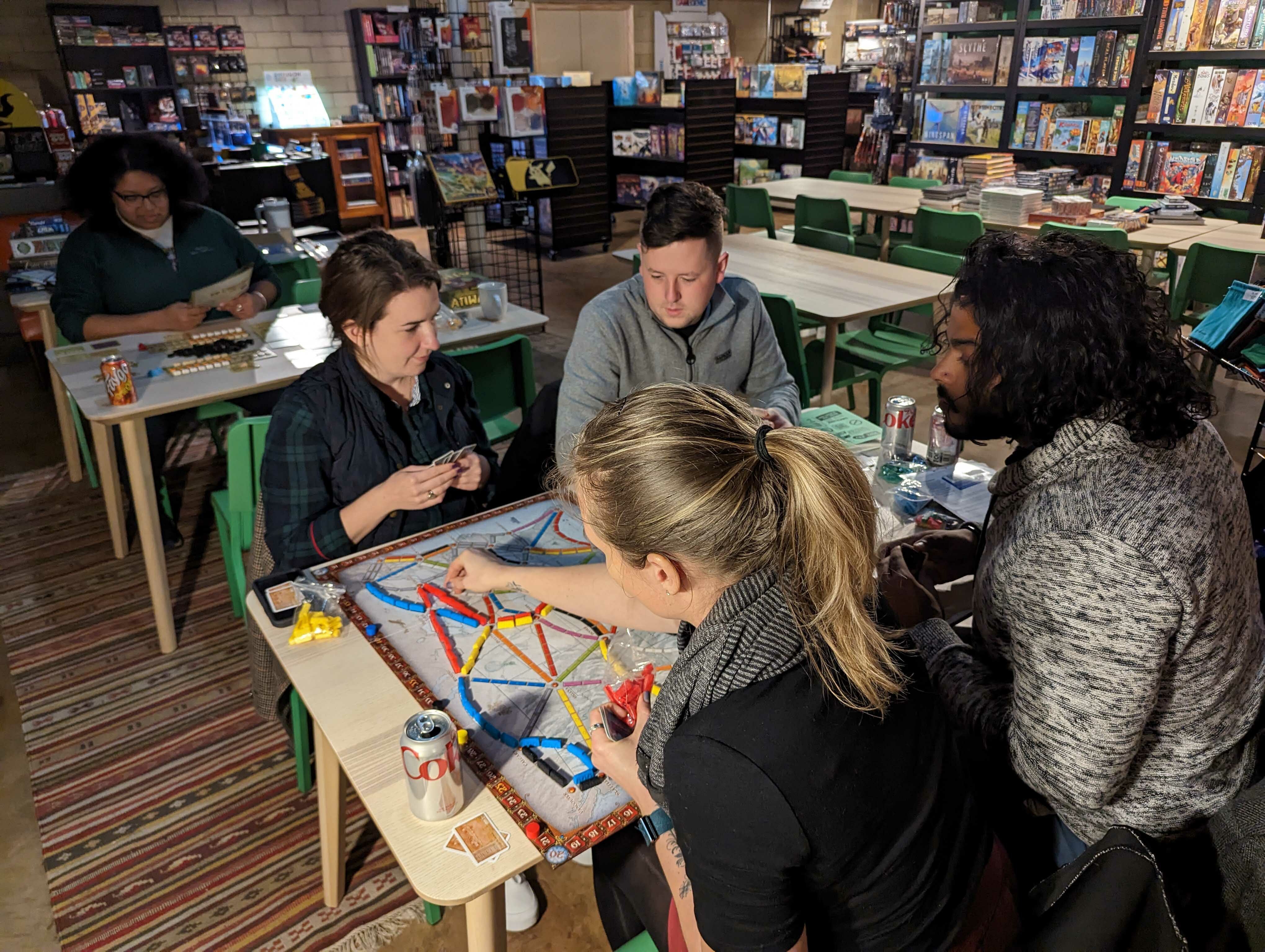 A group plays Ticket to Ride in the Opal Grove Games gaming space. Courtesy photo