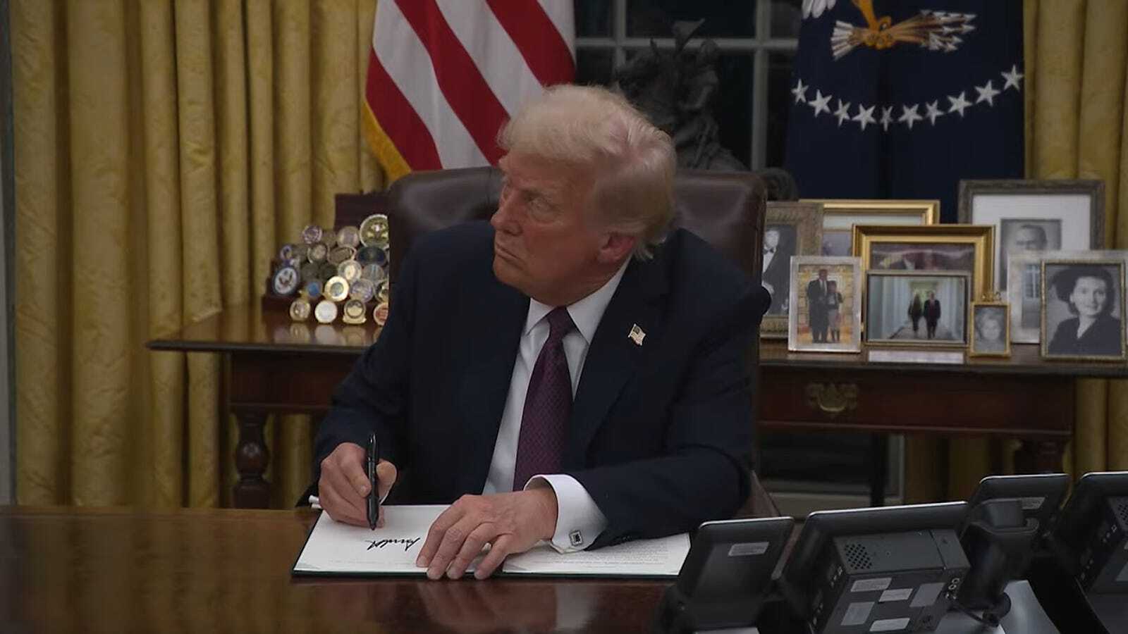 Trump signs the executive order. Photo: The White House.