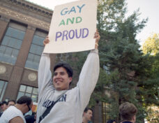 University of Michigan law student Wayne McCabe joins in the celebratory mood Wednesday of a National Coming Out Day rally for gays and lesbians on the U-M diag, Oct 1995 Photo: Ann Arbor District Library, Ann Arbor News
