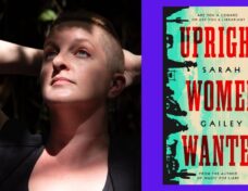 Sarah Gailey, a white person with auburn hair that is long on top and shaved on the sides, looking up with their hands behind their head. Dappled sun and shadow falls across their face, chest, and arms. Photo credit: ©Kate Dollarhyde 2023