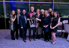 David Custer, center, at the 2026 National Academy of Television Arts & Sciences annual awards event with his Silver Circle induction plaque. Courtesy photo