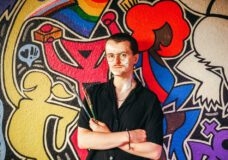 Samuel Turner in front of the mural he painted at Uplift in Ann Arbor. Photo: Andrew Potter