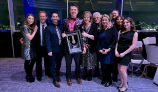 David Custer, center, at the 2026 National Academy of Television Arts & Sciences annual awards event with his Silver Circle induction plaque. Courtesy photo