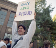 University of Michigan law student Wayne McCabe joins in the celebratory mood Wednesday of a National Coming Out Day rally for gays and lesbians on the U-M diag, Oct 1995 Photo: Ann Arbor District Library, Ann Arbor News