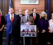 State Sen. Joseph Bellino (R-Monroe), flanked by other GOP lawmakers, speaks at a press conference to pressure the MHSAA to…