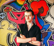 Samuel Turner in front of the mural he painted at Uplift in Ann Arbor. Photo: Andrew Potter