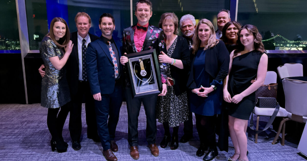 David Custer, center, at the 2026 National Academy of Television Arts & Sciences annual awards event with his Silver Circle induction plaque. Courtesy photo