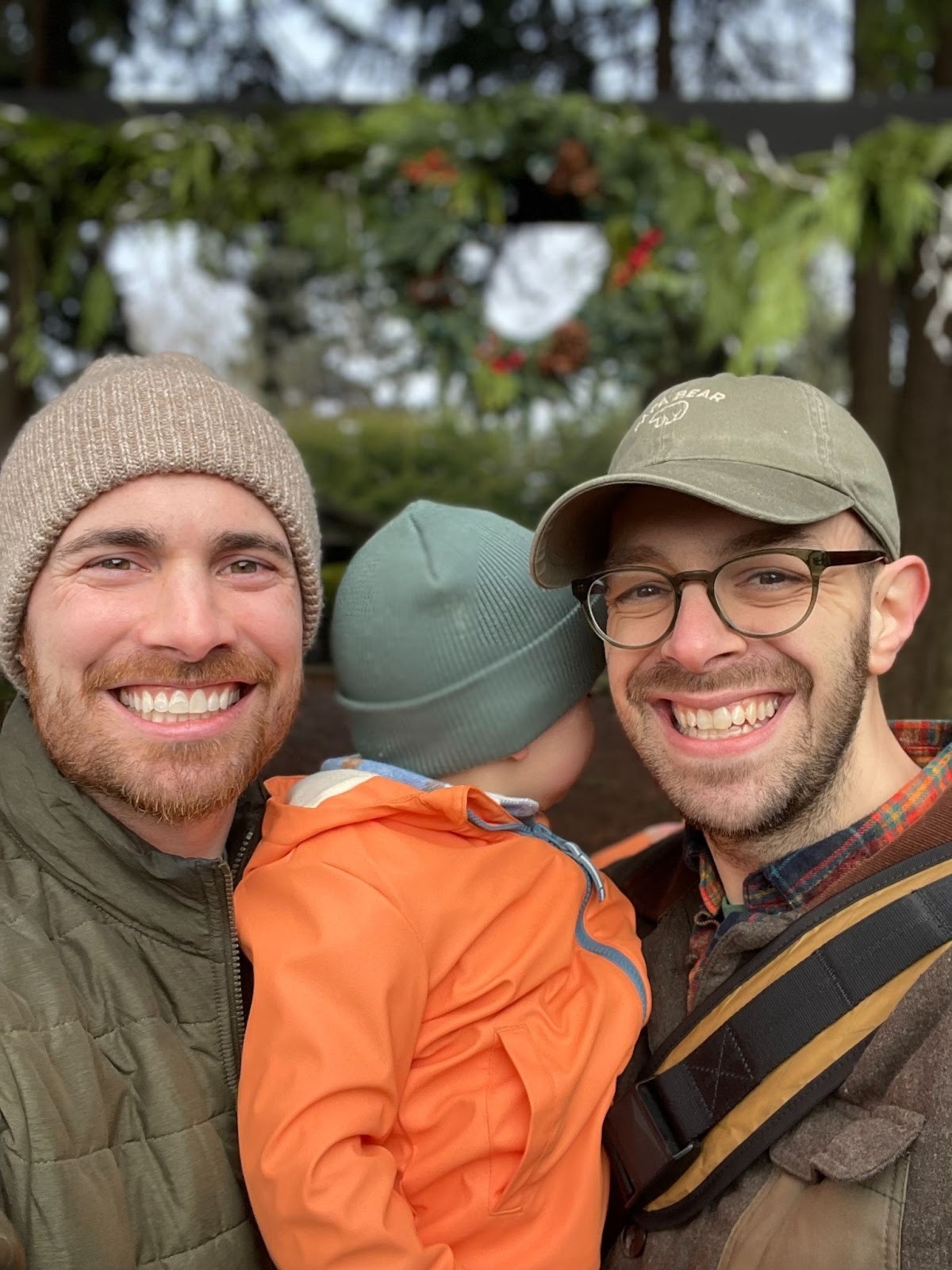 Garth Huelskamp (right) with his husband, Alex, and their son. Courtesy photo