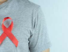Aids Awareness, Red Ribbon On The Man Chest. World Aids Day, Hea