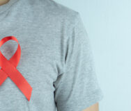 Aids Awareness, Red Ribbon On The Man Chest. World Aids Day, Hea