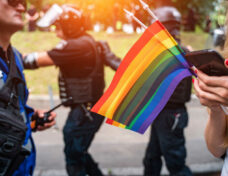 Hand hold a gay lgbt flag at LGBT gay pride parade festival-070712301