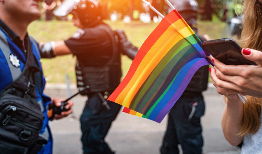 Hand hold a gay lgbt flag at LGBT gay pride parade festival-070712301