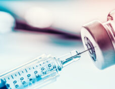 Close-up medical syringe with a vaccine.-070712011