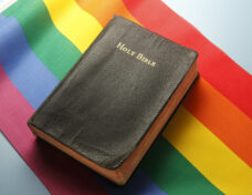 Bible On Top Of Rainbow Flag