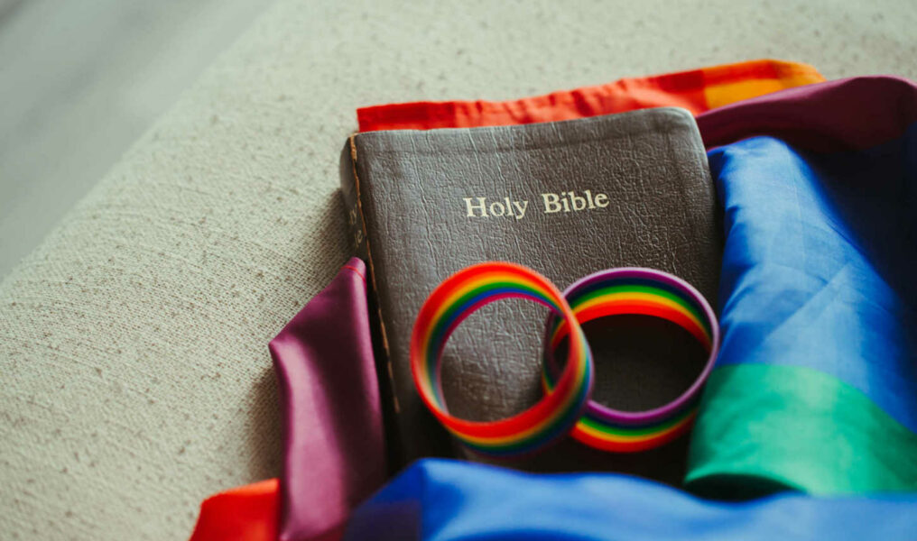 The Holy Bible on rainbow flags, which are the colors that the transgender LGBT community use to show their PRIDE.