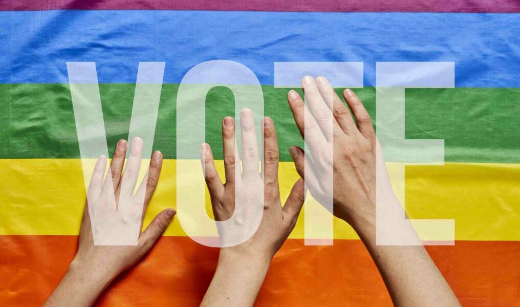 Lgbt People Voting. Lgbt Elections. Hands Of People On Lgbt Flag Background