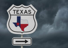 Texas map and state flag on a USA highway road sign