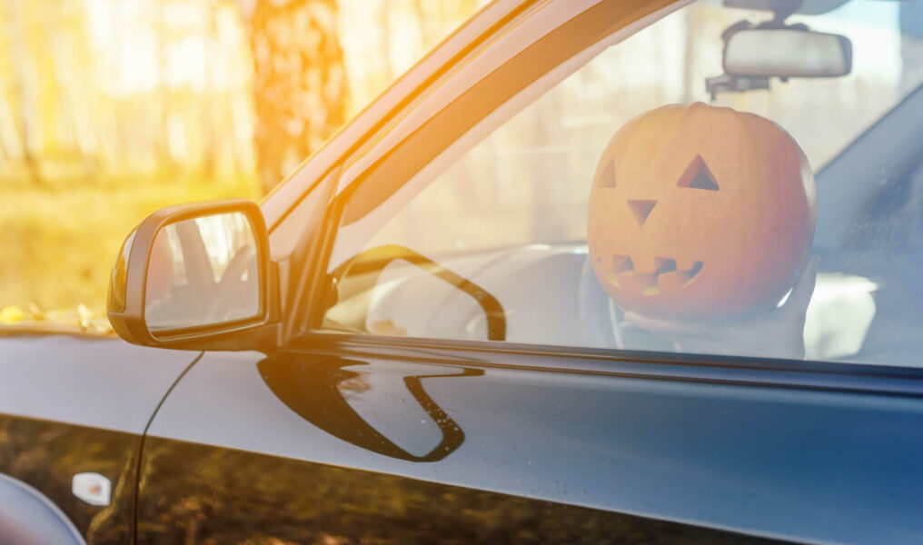 Halloween. Pumpkin in the car on the driver's seat Harvest pumpkin.