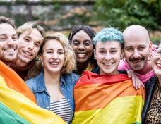 Group of young activist for lgbt rights with rainbow flag, diver