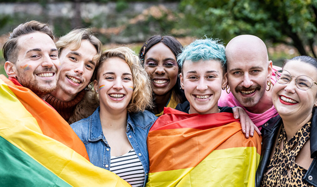 Group of young activist for lgbt rights with rainbow flag, diver