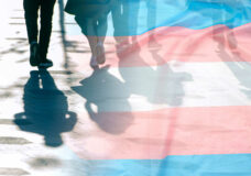 Transgender flag, shadows and silhouettes of people on a road, c