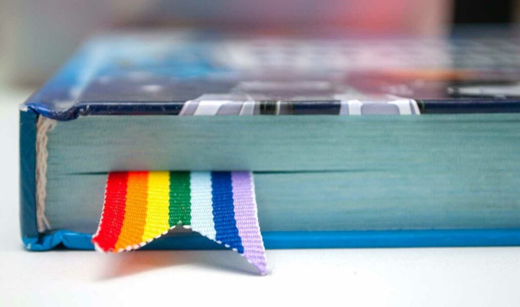 bigstock-Book-With-A-Bookmark-Of-Rainbo-311949847-scaled