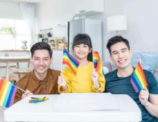 Portrait Of Asian Lgbtq Men Gay Family With Daughter In Living Room. Attractive Handsome Male Couple