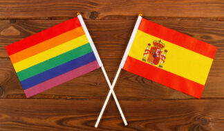Rainbow Flag Lgbt And Flag Of Spain On Brown Wood Planks Backgro