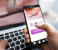 Man Donating Money On Mobile Phone