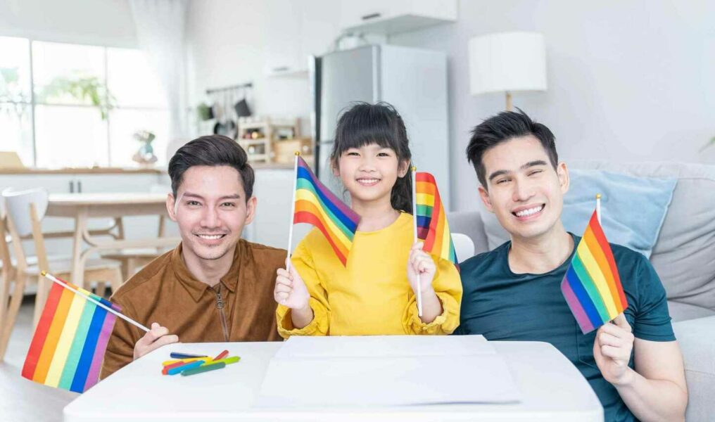 Portrait Of Asian Lgbtq Men Gay Family With Daughter In Living Room. Attractive Handsome Male Couple