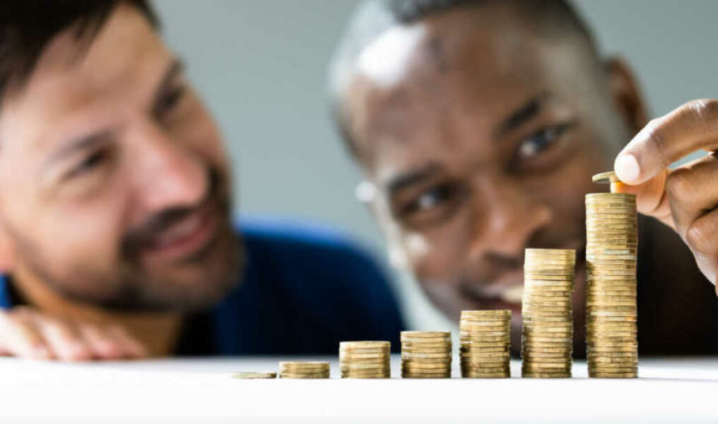 bigstock-Gay-Couple-Money-Save-And-Inve-430379221-scaled